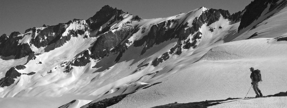 Kam on Sahale Arm with the skyline of Forbidden Peak behind him, N. Cascades (Photo by C. Cass)